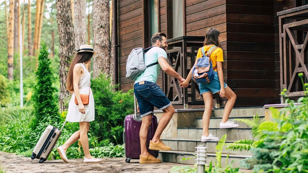 People walking into a house