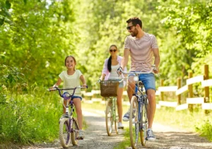 a family riding on bikes on a gravel path