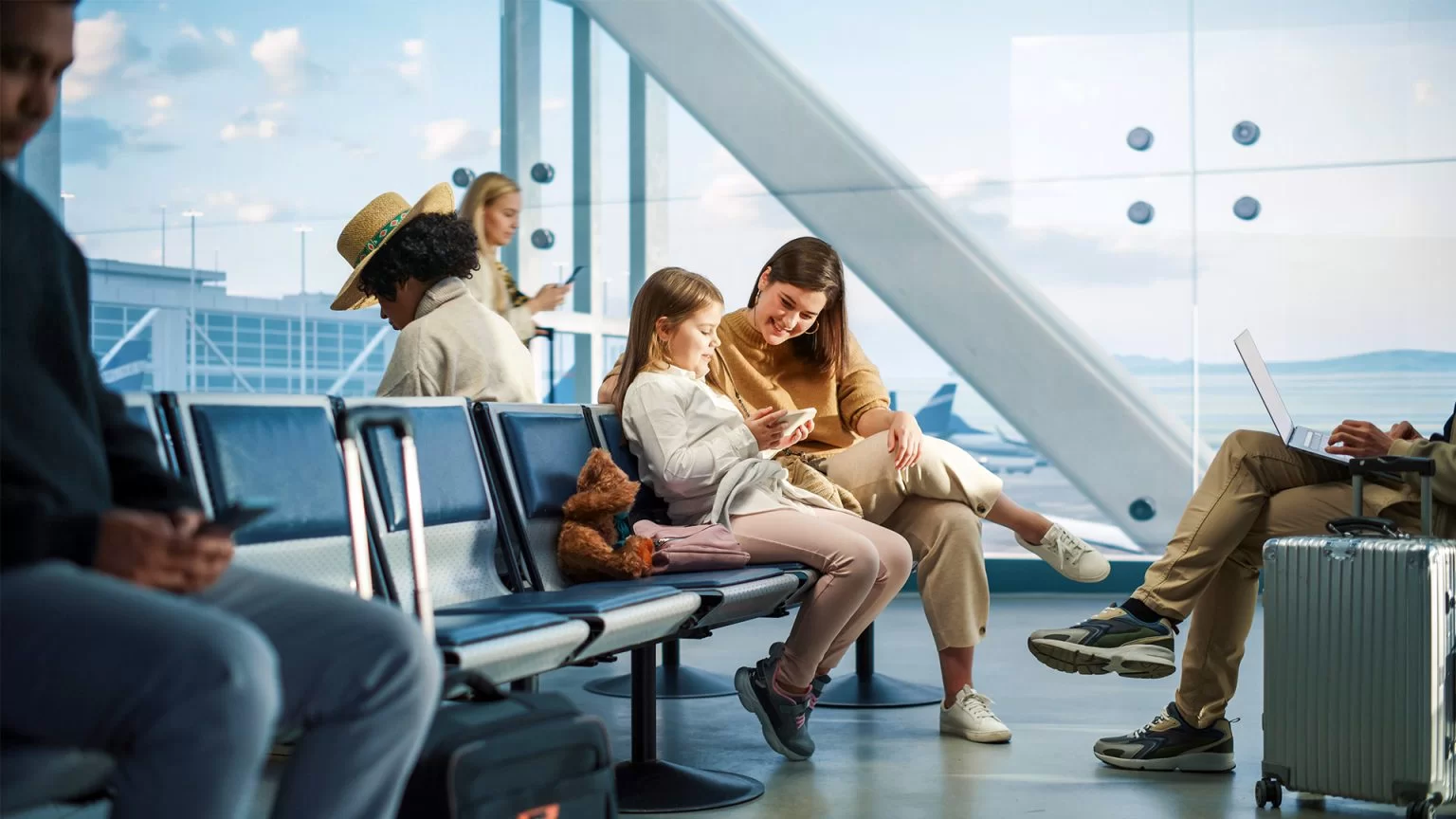 mom with daughter sitting in an airport