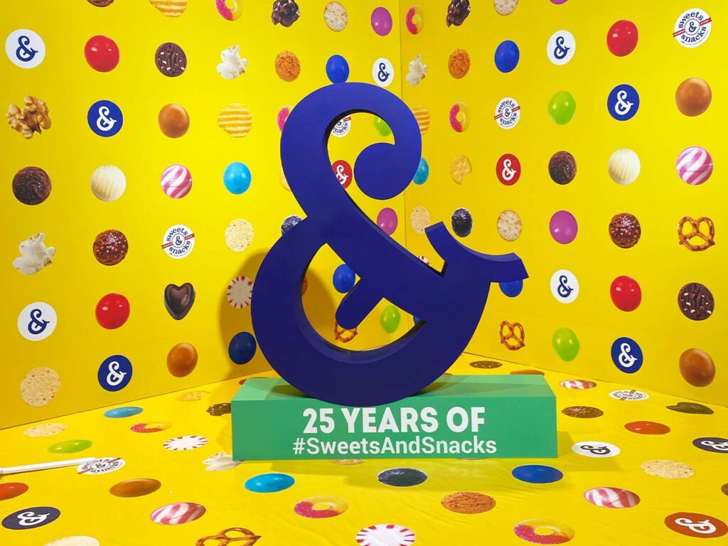 Ampersand selfie station with candy background