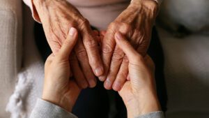 person holding a older person's hands