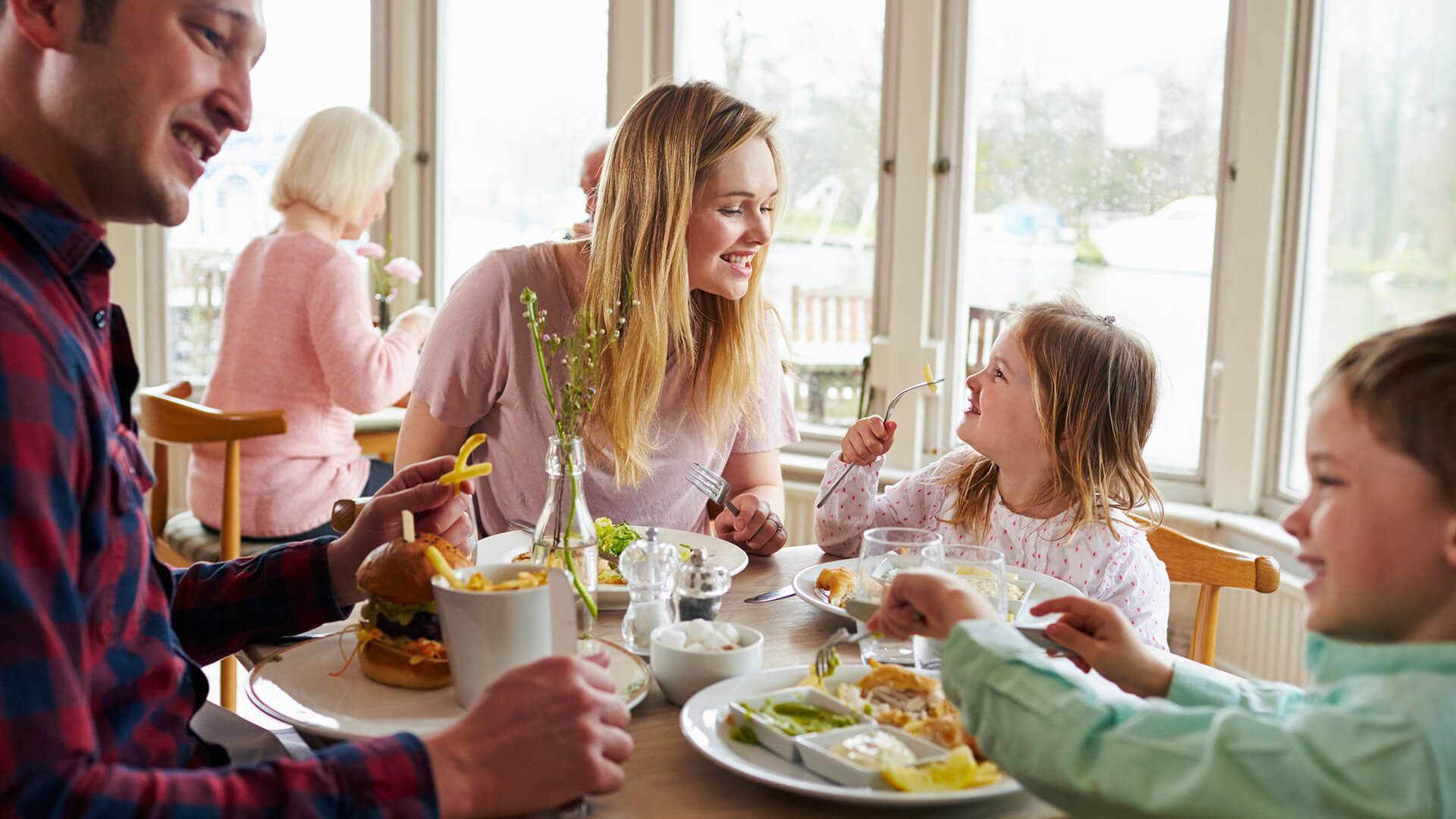 family gathered around table eating meal
