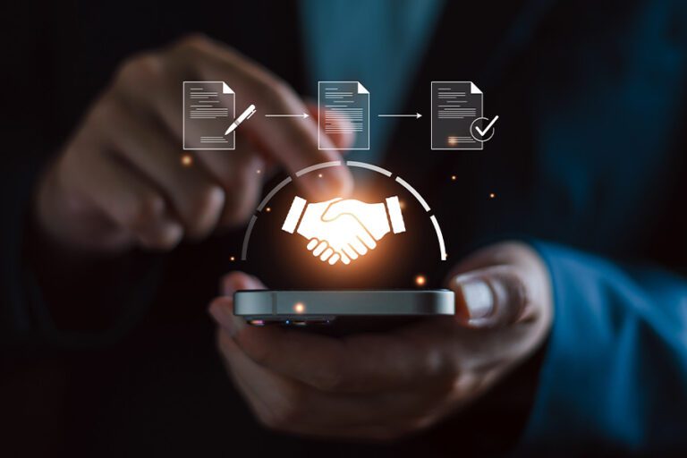 person holding a globe with a shining image of a handshake inside
