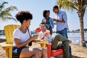 A group of friends enjoying drinks and conversation by the waterfront in Baltimore County, reflecting the welcoming experiences highlighted in the Discover Baltimore County tourism rebrand.