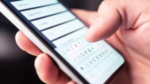 Close-up of a person using a mobile form, highlighting the need for websites to be easy to use on phones.