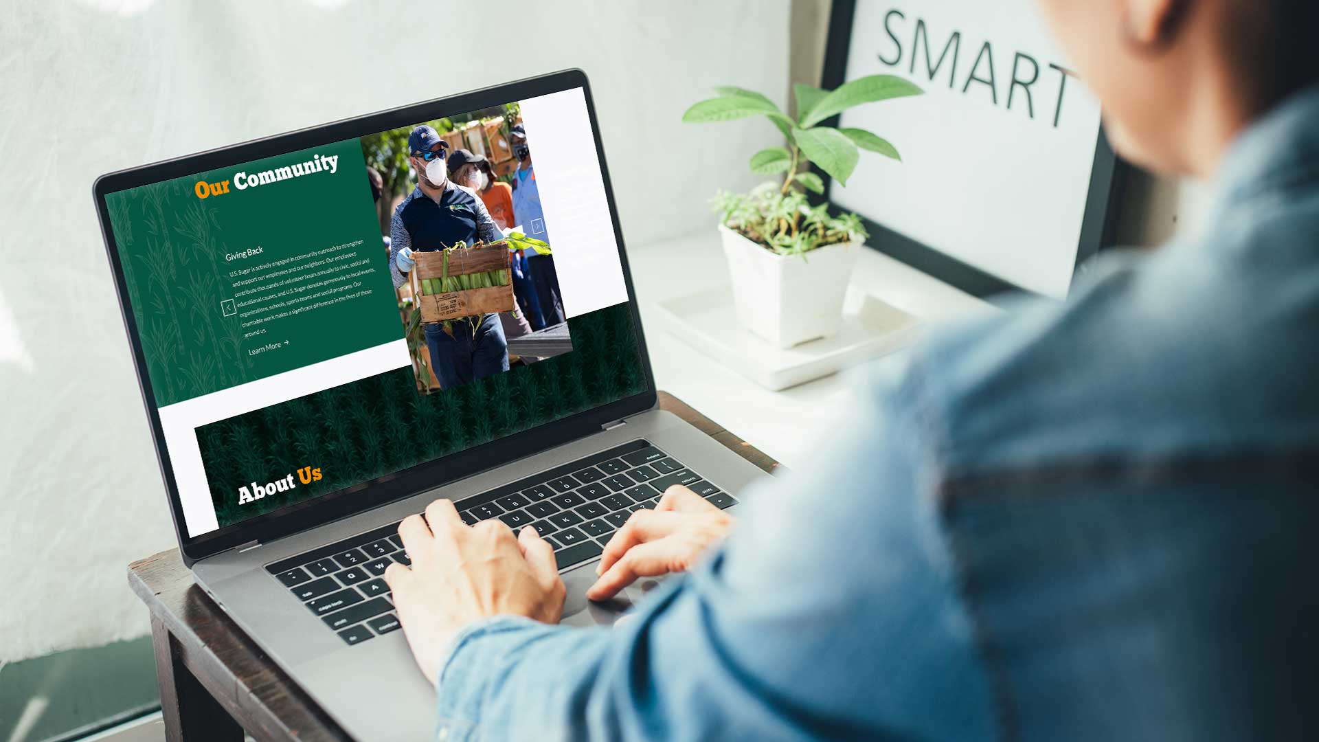 Person viewing a modern foodservice website on a laptop, representing a refreshed website designed to support brand credibility and user engagement.